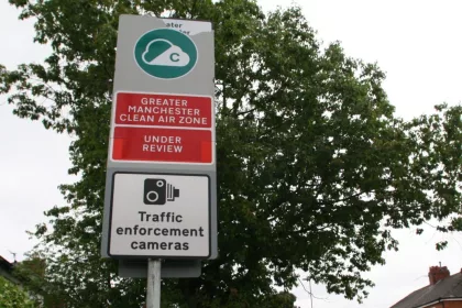 Sign showing Manchester Clean Air Zone under review