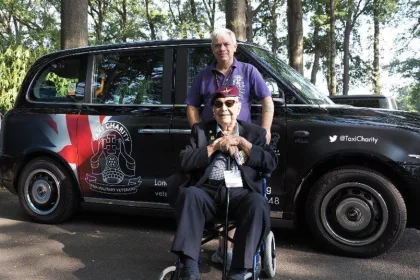 Micky Harris in front of black cab