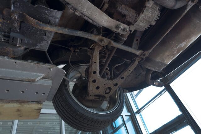 Underside of a car having work done in a garage