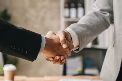 Two confident business man shaking hands during a meeting in the office, success, dealing, greeting and partner
