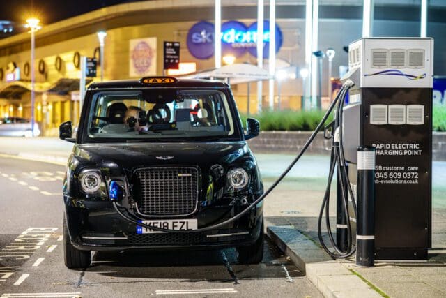Electric Taxi is charging on street doc station in the town centre of Coventry