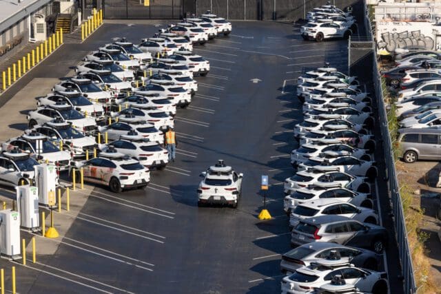 waymo depot with rows of driverless taxis parked