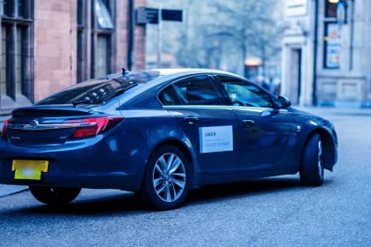 Blue uber on empty road