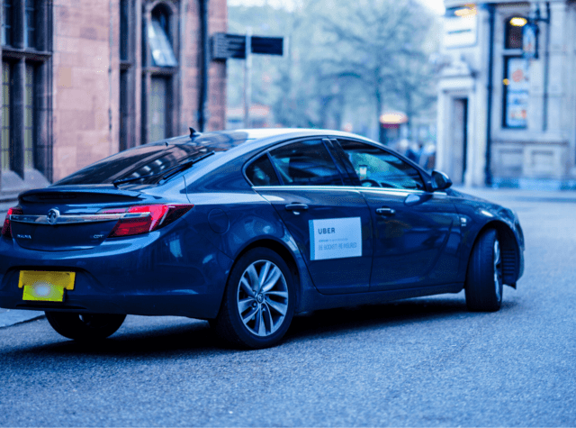 Blue uber on empty road