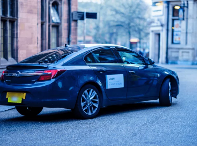 Blue uber on empty road