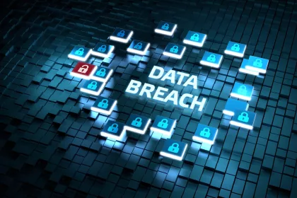 The image depicts a digital representation of a "Data Breach" scenario. The words "DATA BREACH" are prominently displayed in the center, surrounded by various digital lock icons. Most of the lock icons are blue and closed, while one lock is red and open. The background consists of a grid of three-dimensional, dark-colored cubes.