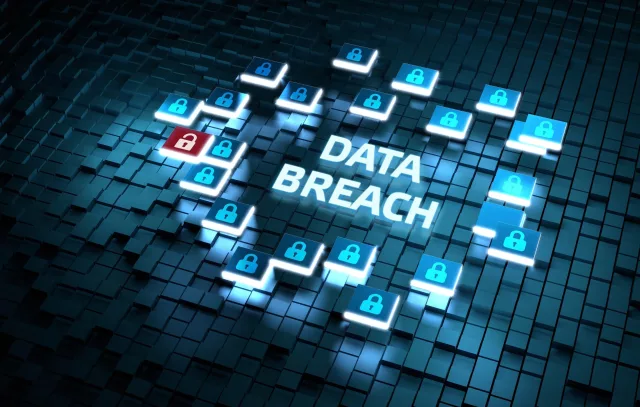 The image depicts a digital representation of a "Data Breach" scenario. The words "DATA BREACH" are prominently displayed in the center, surrounded by various digital lock icons. Most of the lock icons are blue and closed, while one lock is red and open. The background consists of a grid of three-dimensional, dark-colored cubes.