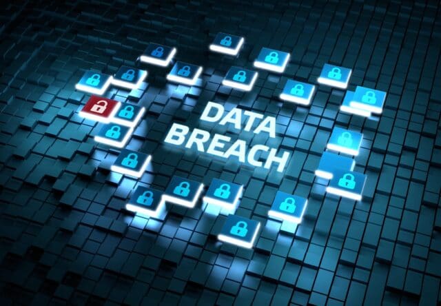 The image depicts a digital representation of a "Data Breach" scenario. The words "DATA BREACH" are prominently displayed in the center, surrounded by various digital lock icons. Most of the lock icons are blue and closed, while one lock is red and open. The background consists of a grid of three-dimensional, dark-colored cubes.