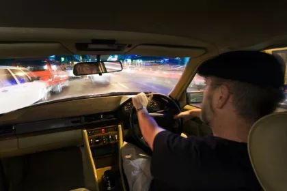 private hire taxi driver at the wheel on the motorway