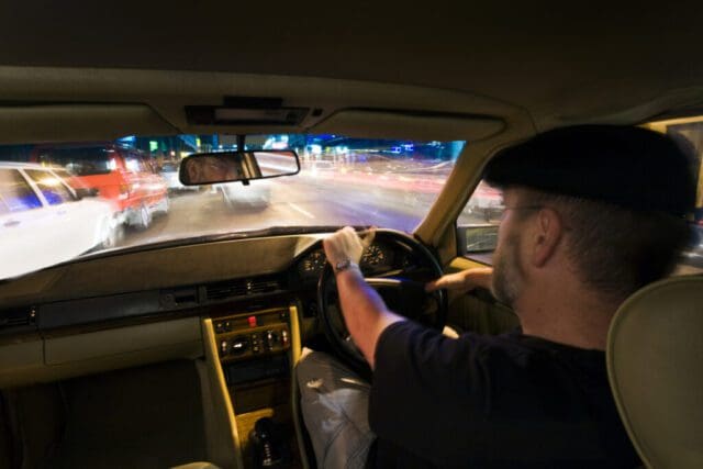 private hire taxi driver at the wheel on the motorway