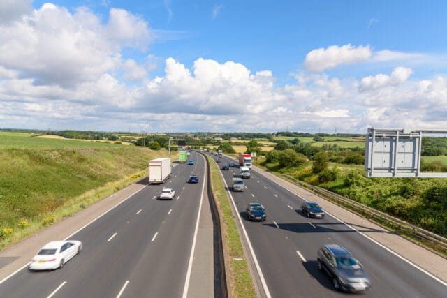 Three-lane motorway in the countryside of England on a sunny summer day. South Yorkshire, England, UK