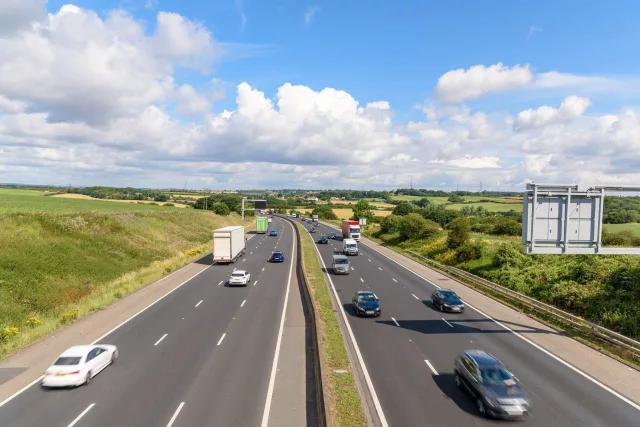 Three-lane motorway in the countryside of England on a sunny summer day. South Yorkshire, England, UK