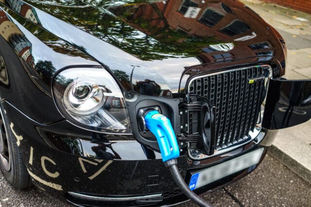 London Black Cab (London taxi), New Electric Taxi is charging on street with fast charge, Car made by London Taxi Company based in Coventry.