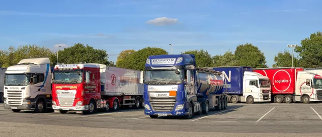 Articulated lorries parked in a row at the M5 motorway service station at Strensham.