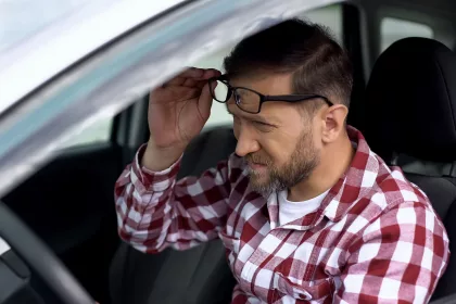 Tired driver taking eyeglasses off