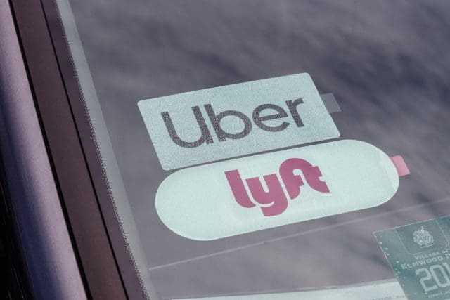 Uber and Lyft stickers displayed in a private hire vehicle