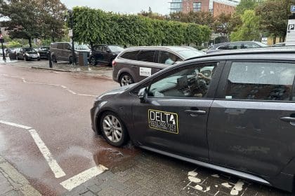 Delta taxi and uber crossing paths at the Albert Dock in Liverpool. Taxi licensing fees in Liverpool are set to rise for the first time in 15 years.