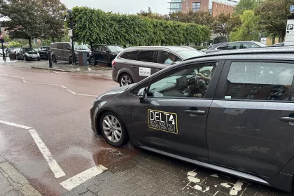 Delta taxi and uber crossing paths at the Albert Dock in Liverpool. Taxi licensing fees in Liverpool are set to rise for the first time in 15 years.