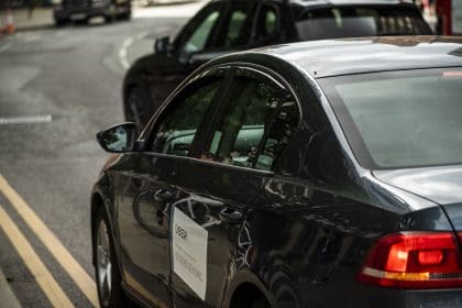 private hire vehicle with uber sticker on door