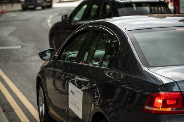 private hire vehicle with uber sticker on door