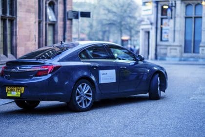 UBER Car in an English city centre. The decision has been made to extend the trial of allowing Cash Payments for UBER trips