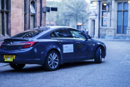 UBER Car in an English city centre. The decision has been made to extend the trial of allowing Cash Payments for UBER trips