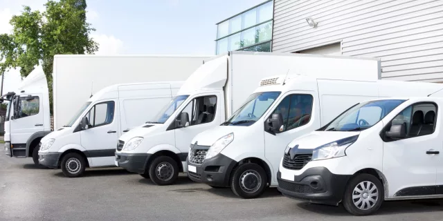 Mixed vehicle fleet. Several cars vans trucks parked next to each other.