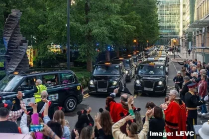 Taxis from the Magical Taxi Tour line the streets and are waved off by a crowd of people as they leave for their 30th annual trip to Disneyland Paris. Image credit: LEVC