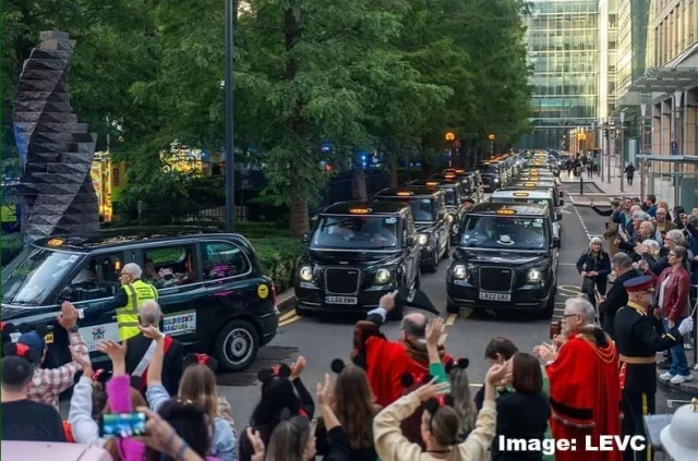 Taxis from the Magical Taxi Tour line the streets and are waved off by a crowd of people as they leave for their 30th annual trip to Disneyland Paris. Image credit: LEVC