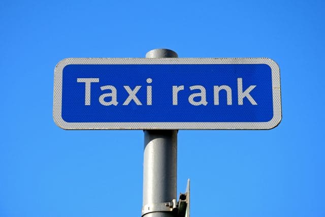 Taxi rank sign against a blue sky