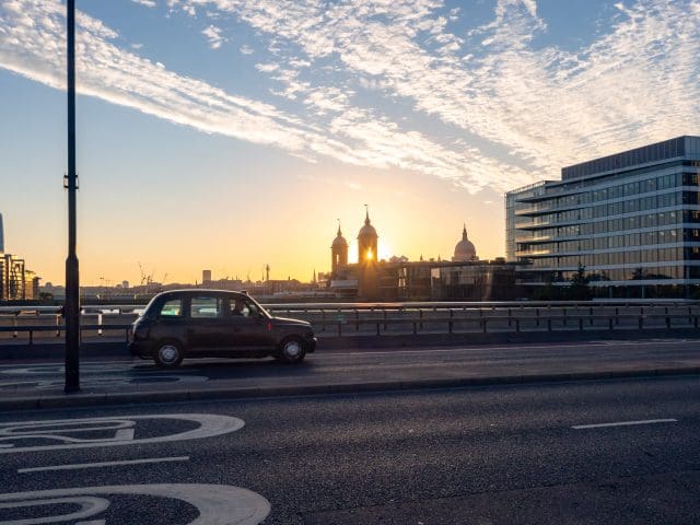 Taxi cab crossing London Bridge, UK