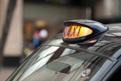 Close up of a London black cab with yellow light on