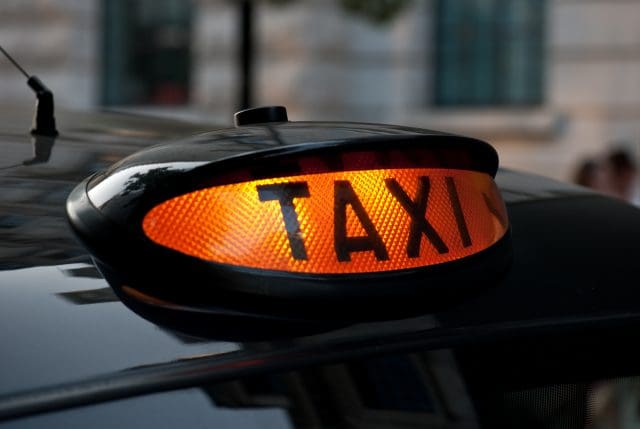 Illuminated London taxi sign, ready for hire.