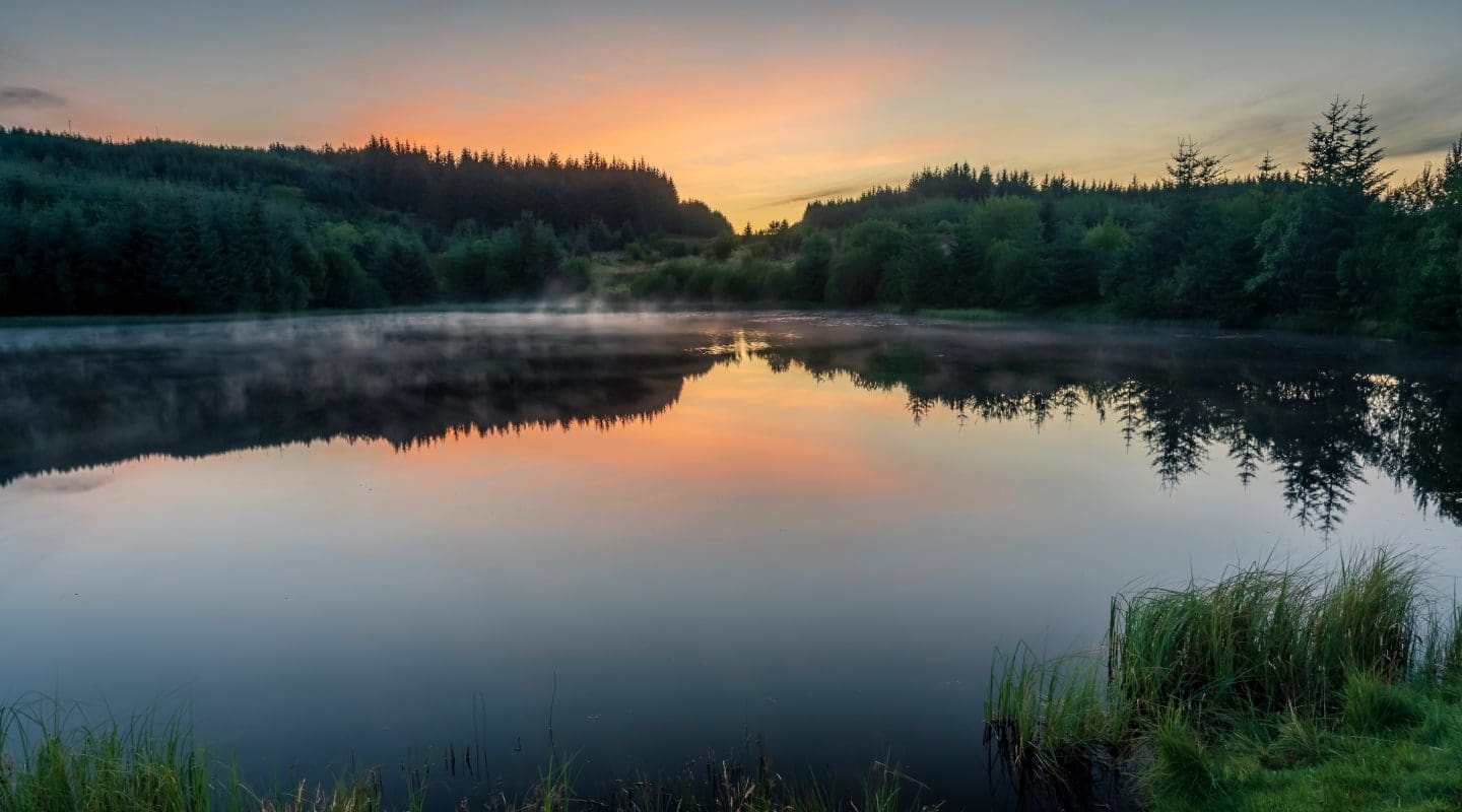 As night falls the last light of the day strikes Ladymuir Reservoir.