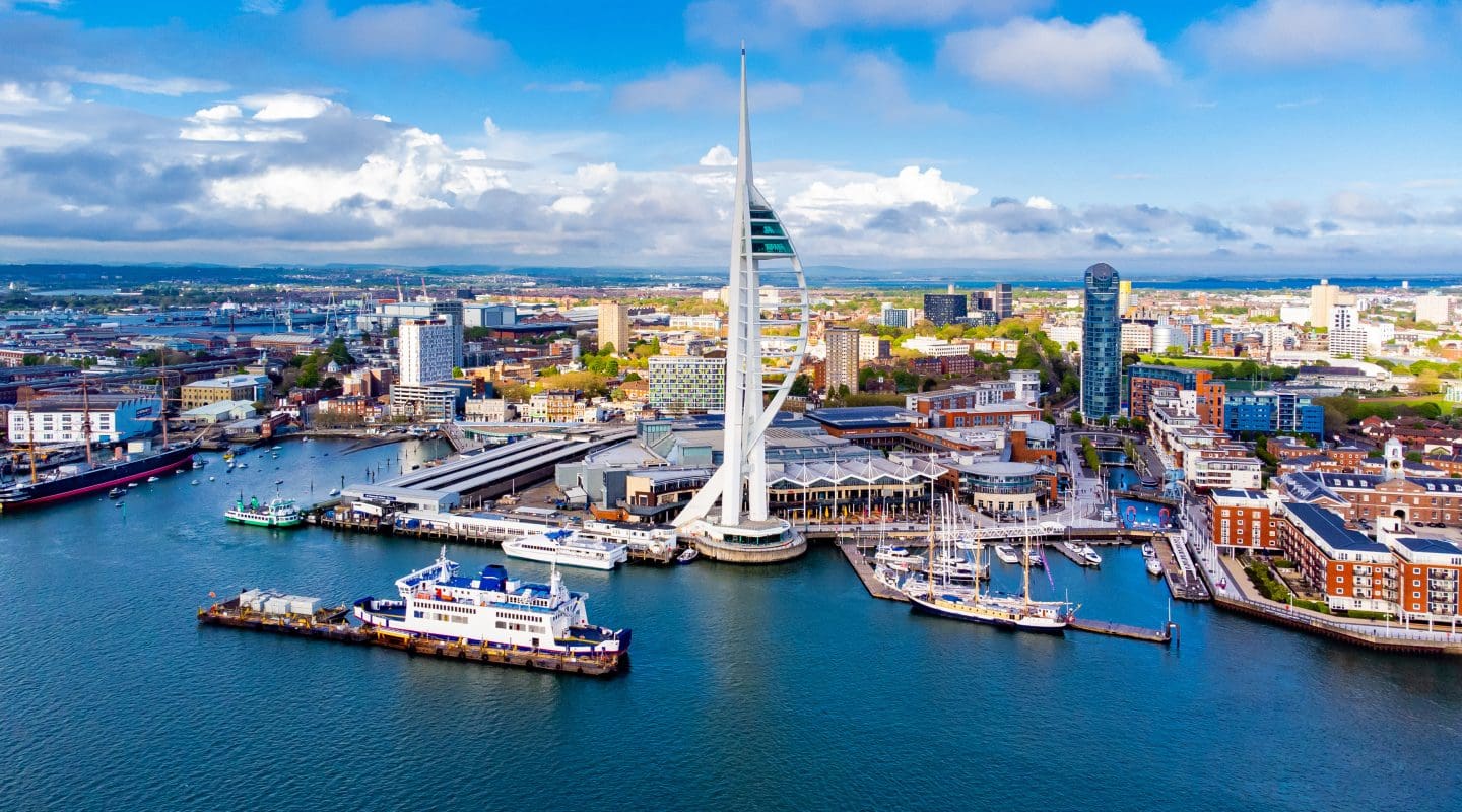 Aerial view of the sail-shaped Spinnaker Tower in Portsmouth Harbor in the south of England on the Channel coast - Gunwharf Quays modern shopping mall in a residential waterfront area