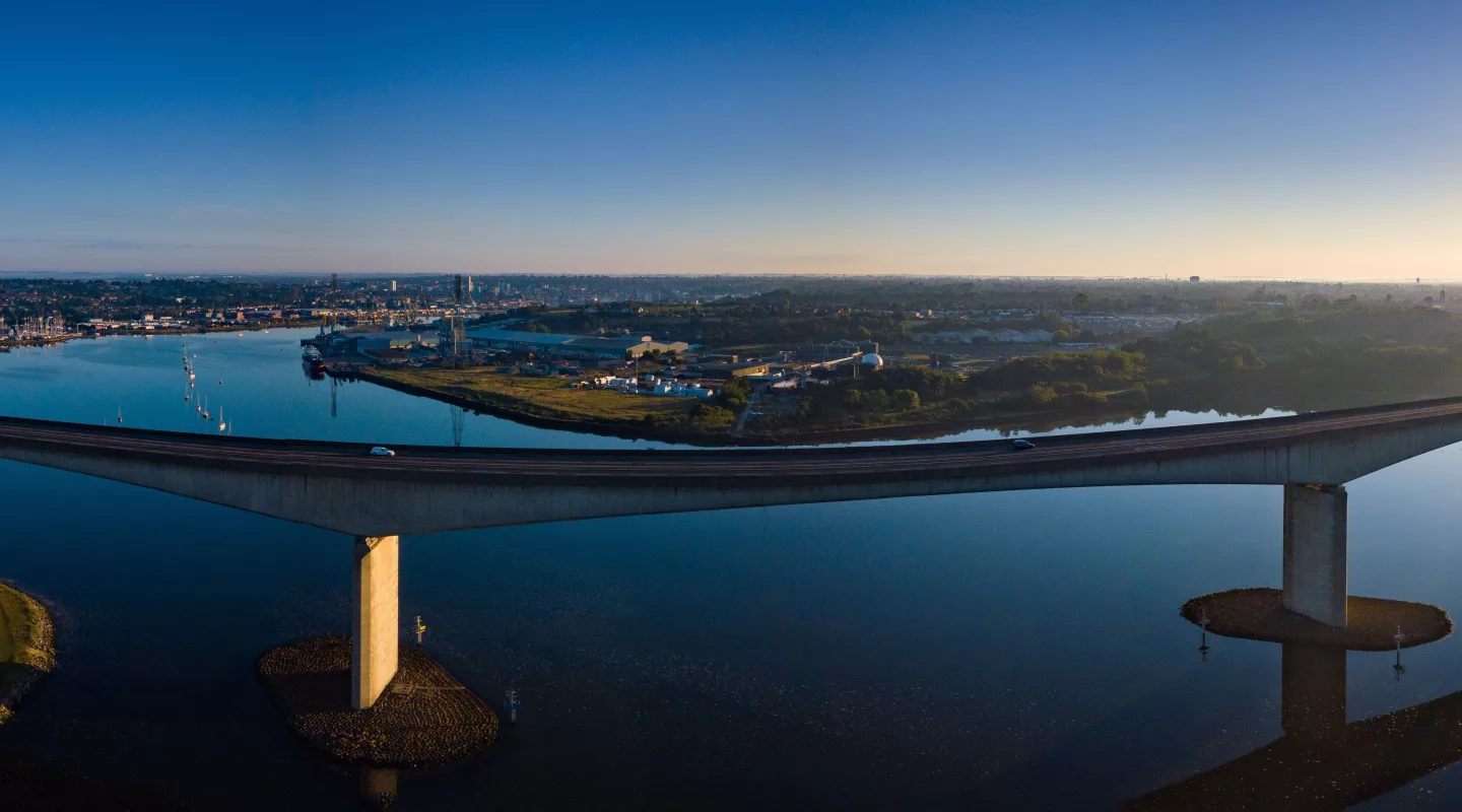 Aerial panorama of Orwell Bridge with sunrise and Ipswich city in the background.