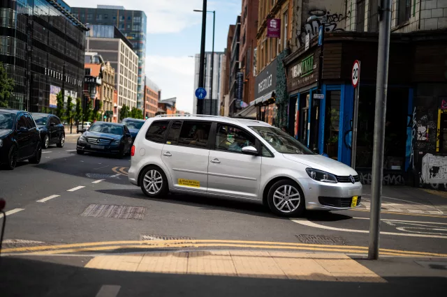 private hire vehicle driving around corner