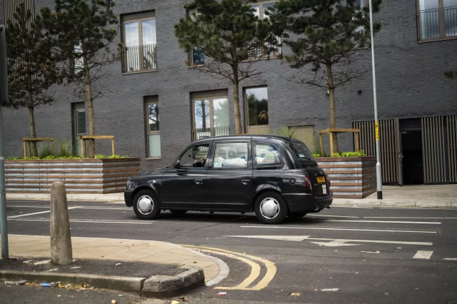 taxi driving on city street