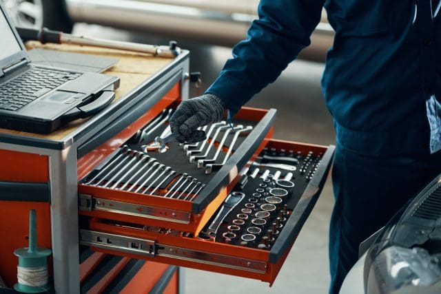 Mechanic taking wrench out of a toolbox