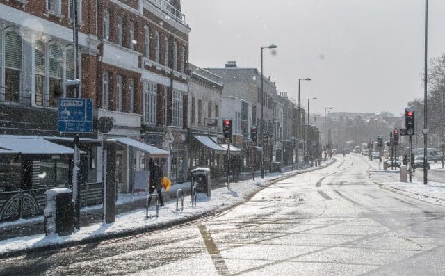 Snowy icy road in the UK. Professional drivers should take extra care driving in winter conditions.