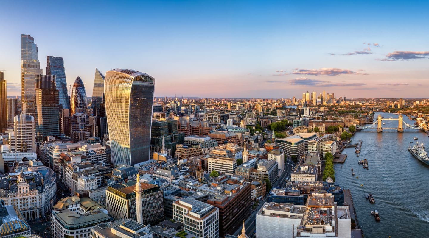 Panoramic aerial view of the City of London skyline with Tower Bridge and the River Thames during sunset time