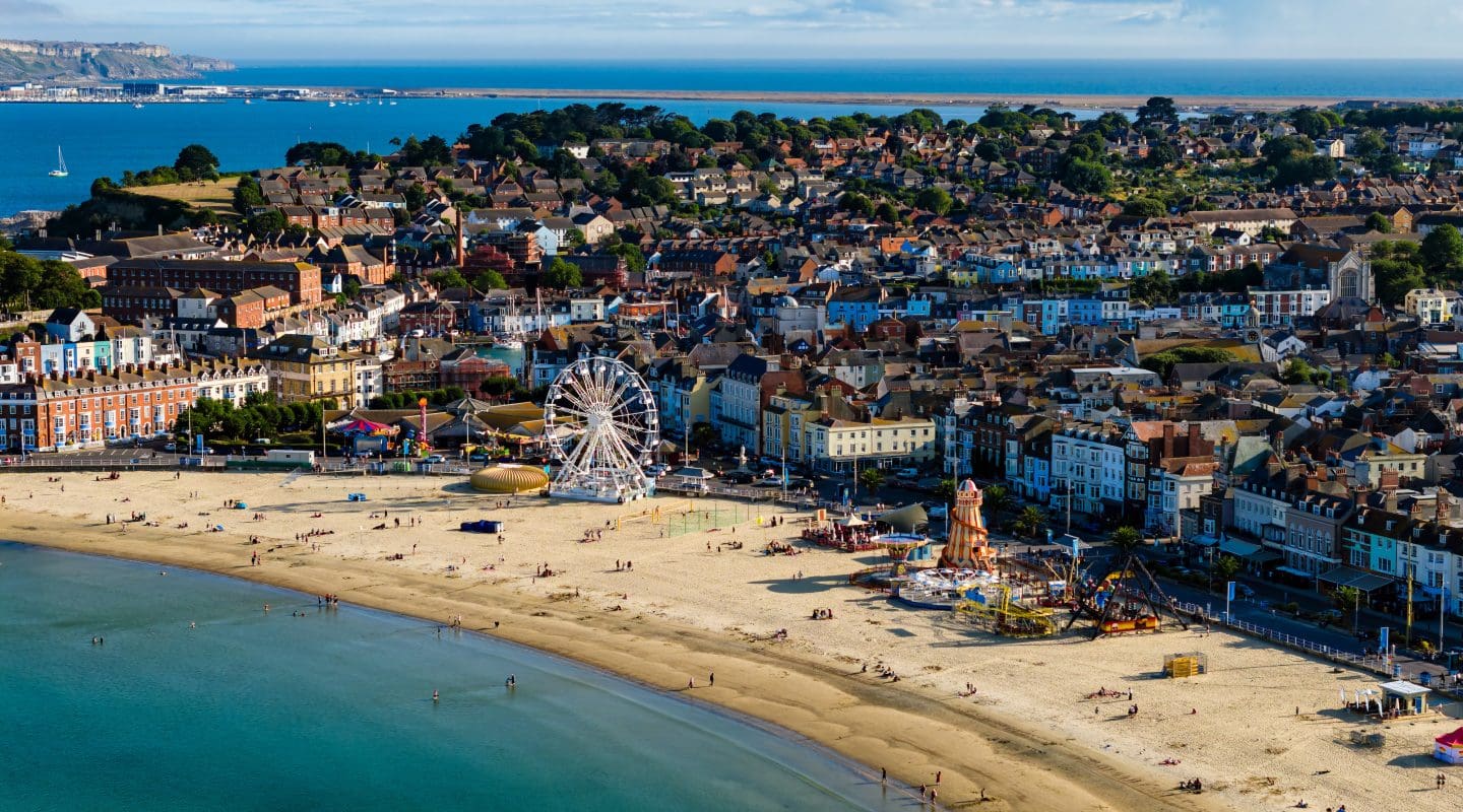 sandy beach and funfair at Weymouth on the Jurassic Coast.