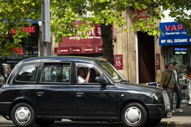 black cab taxi parked on city street