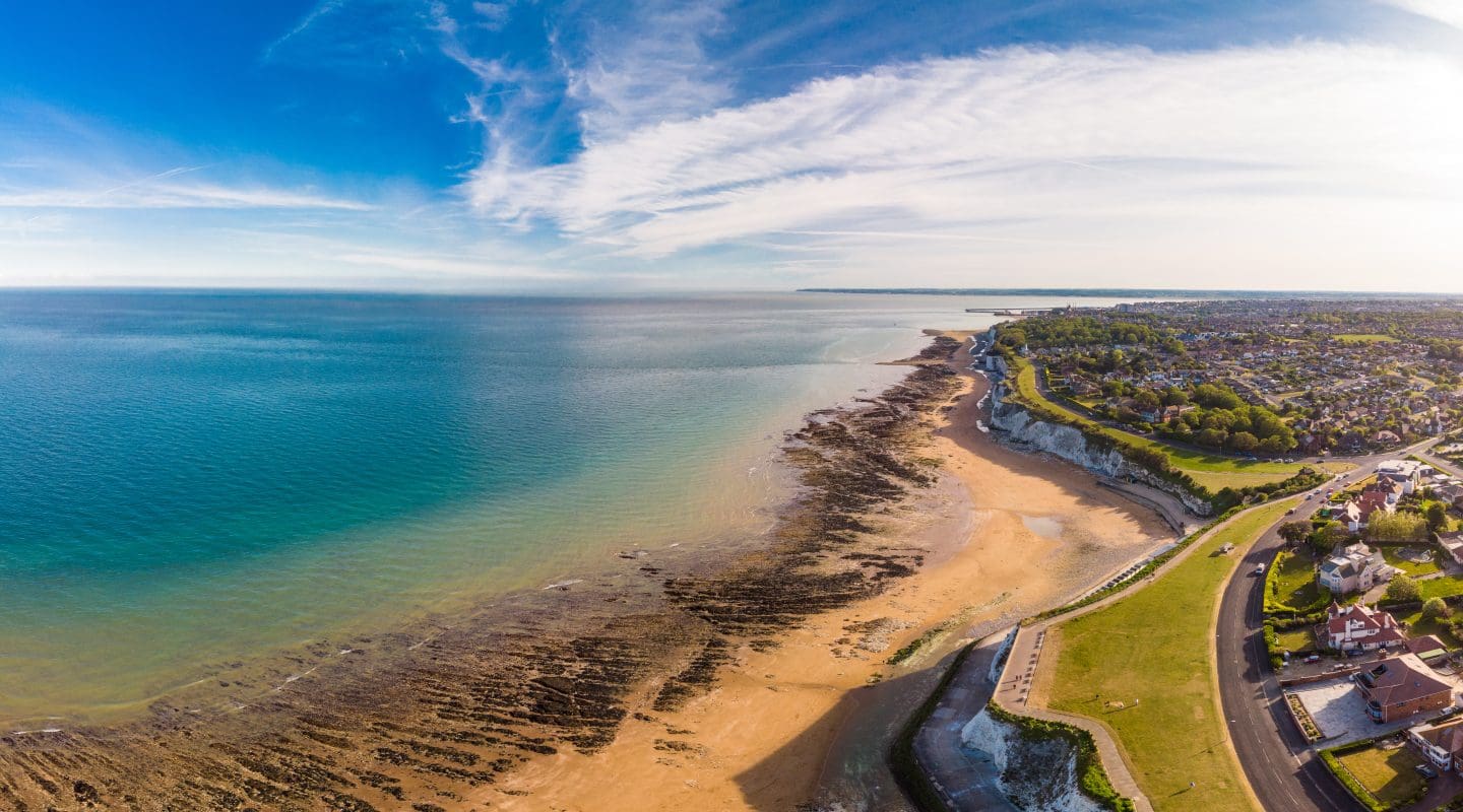 Drone aerial view of the beach and white cliffs on sunny day, Margate, England, UK