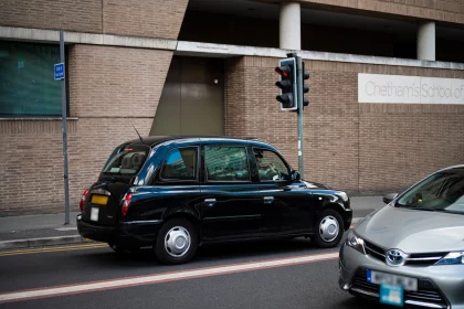 public hire and private hire taxi passing on a city street