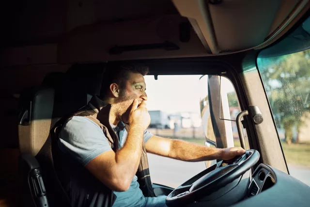 fleet driver yawning at the wheel