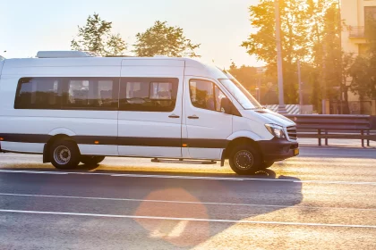 white minibus driving on city street