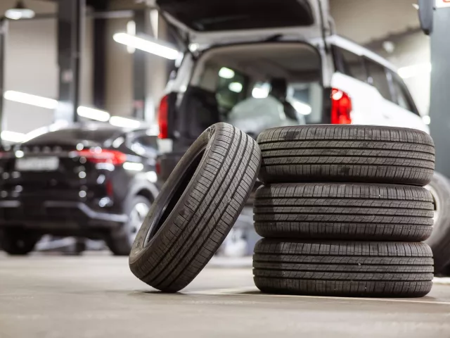 Pile of car tyres in a motor trade garage