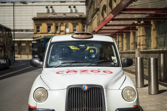White hackney carriage taxi parked in taxi rank