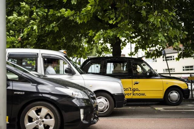 Hackney carriage taxis waiting at traffic lights